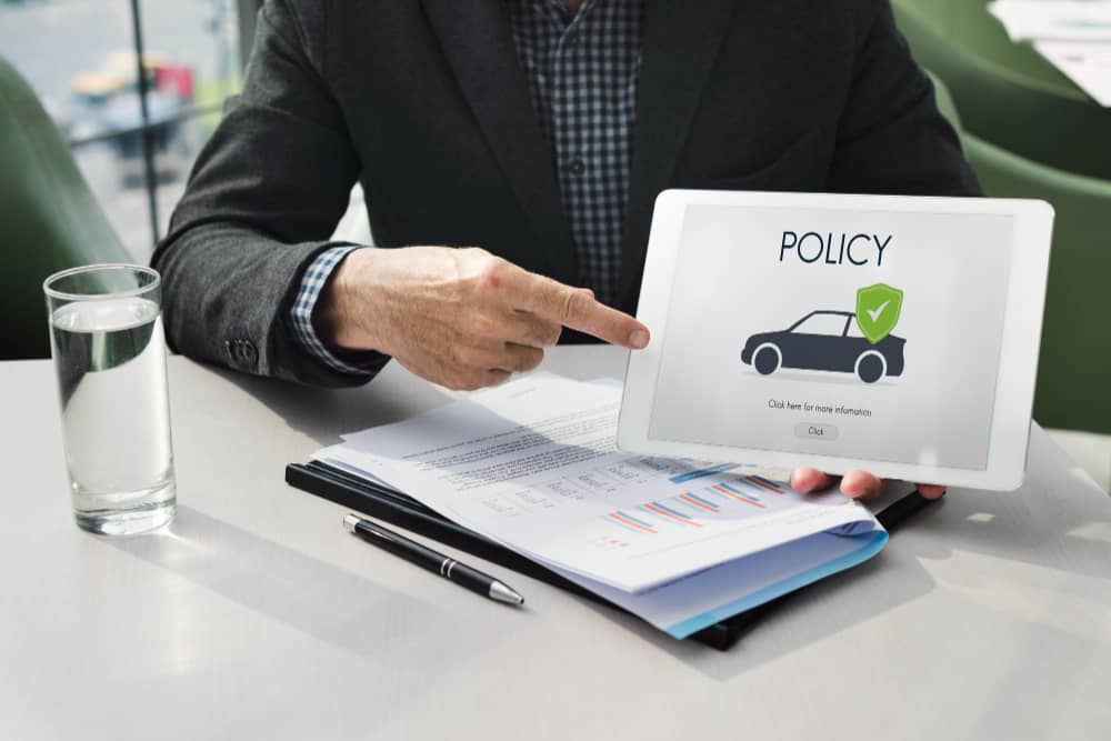 Insurance policy displayed on a tablet with a car icon