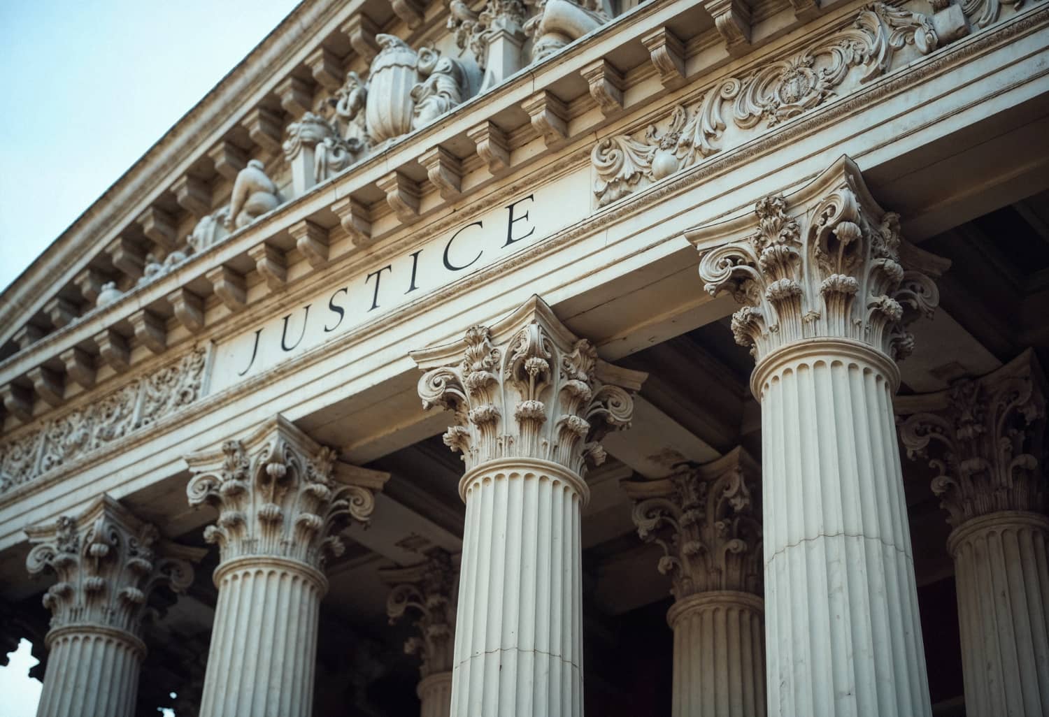 Courthouse columns engraved with the word Justice