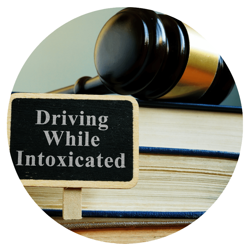 Driving While Intoxicated sign in front of a gavel and law books