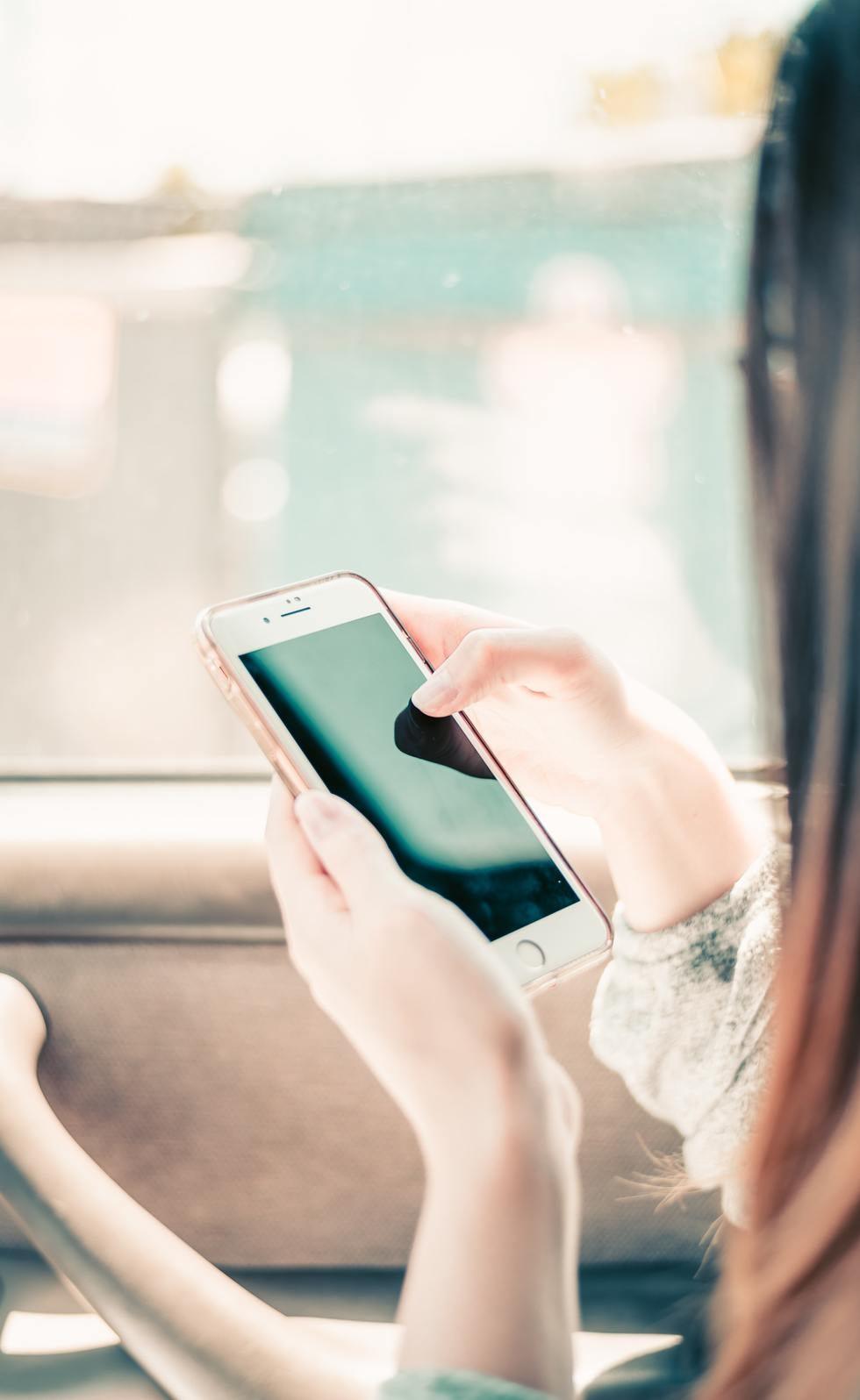 Close up of hands holding and using a smartphone