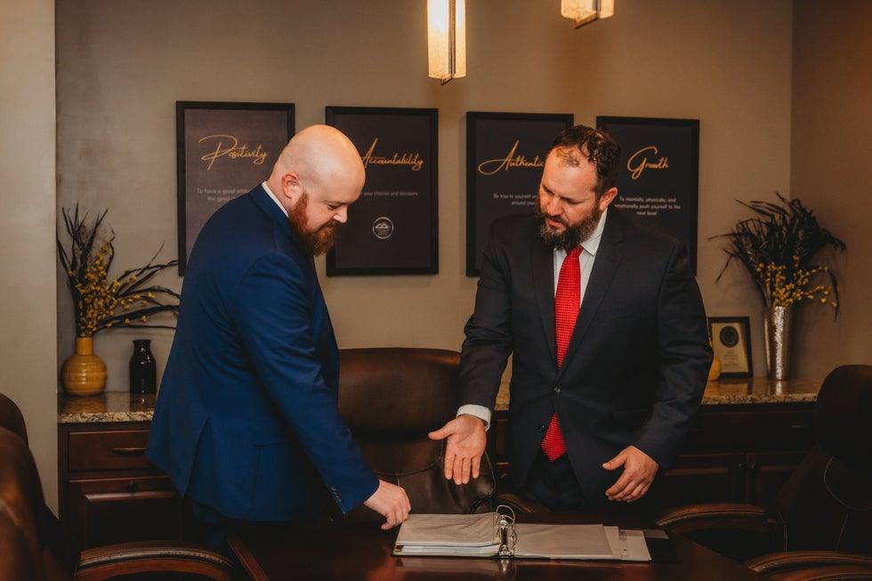 Two Higher Level Legal attorneys reviewing documents together