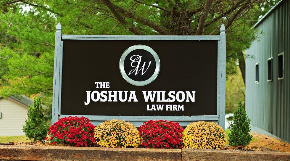 The Joshua Wilson Law Firm sign outside the Higher Level Legal office in Raymore, Missouri