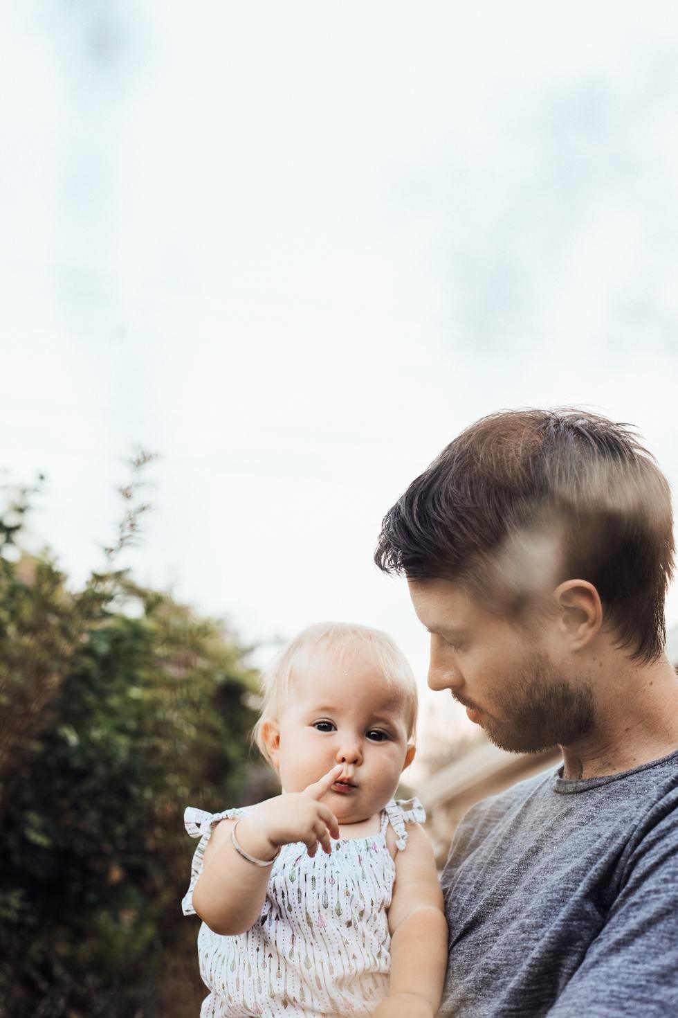 Father holding a thoughtful looking infant