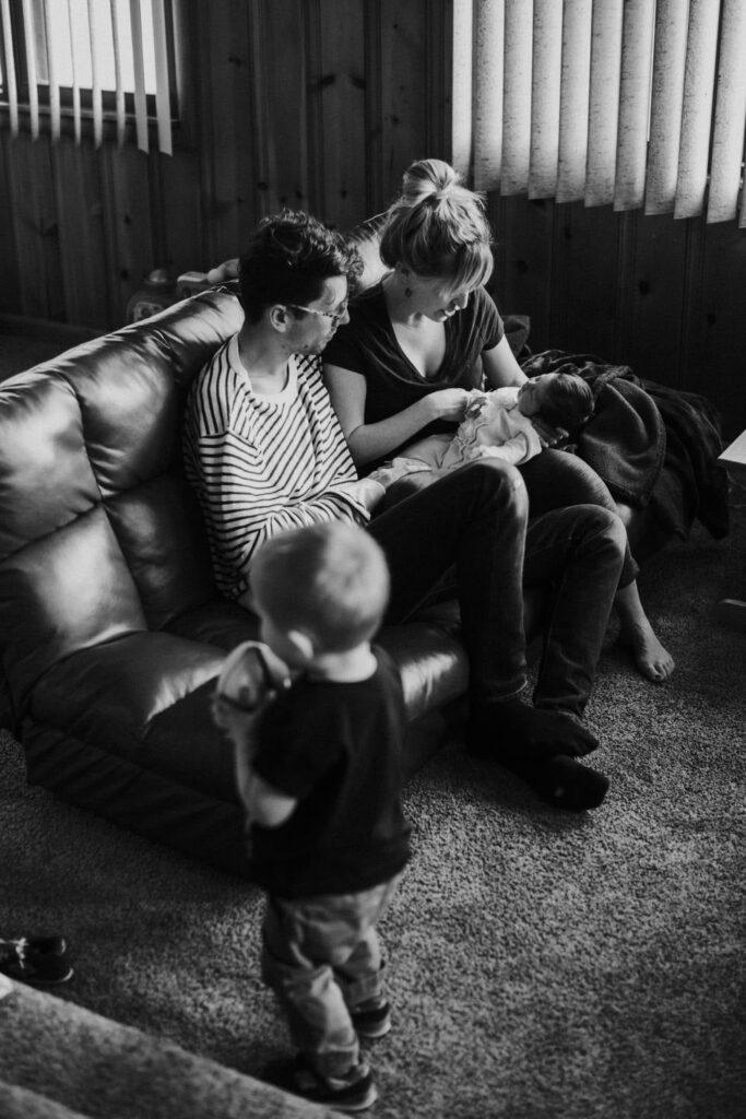 Family On Couch Mom And Dad Bw