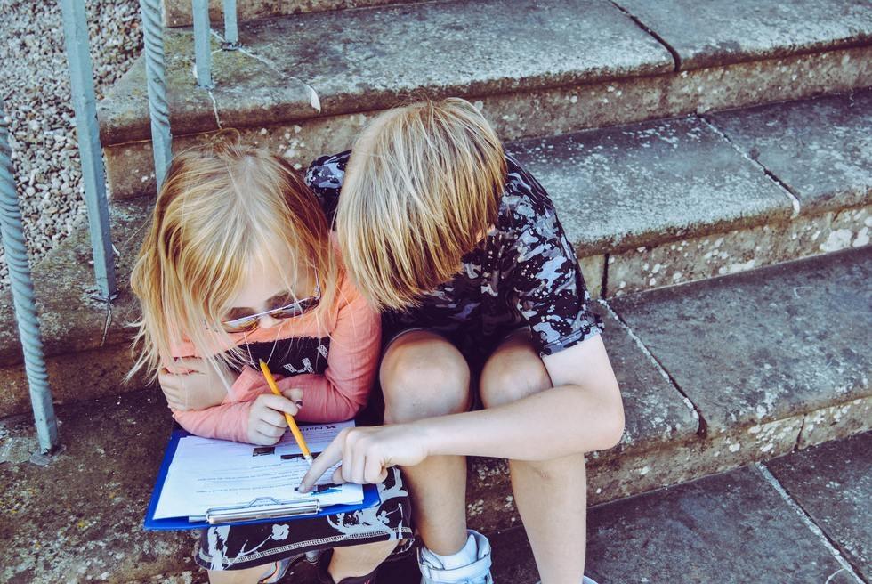 Children writing at a table