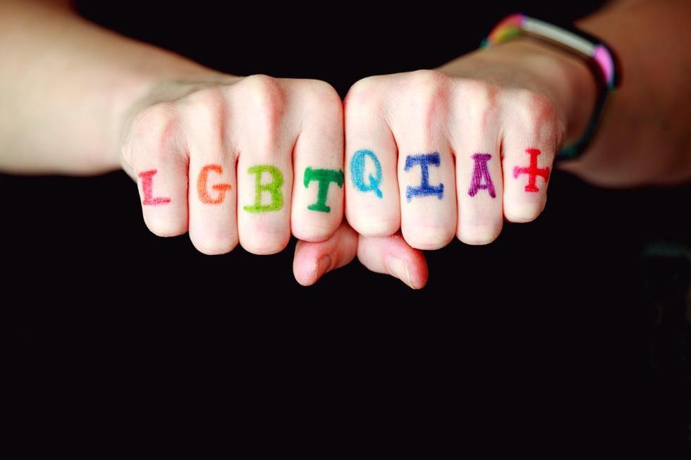Close up of knuckles with rings symbolizing LGBTQ pride