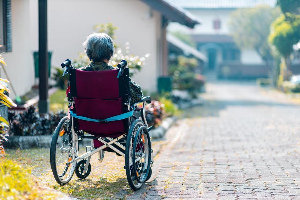 Old Lady In Wheel Chair